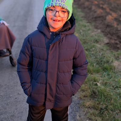 Ein Junge steht auf dem feld und lacht in die Kamera